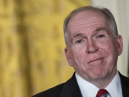 John Brennan smiles as US President Barack Obama pauses during an event in the East Room o