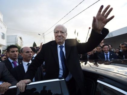 Tunisian presidential candidate for the anti-Islamist Nidaa Tounes party, Beji Caid Essebsi reacts after placing his vote on December 21, 2014 in Tunis. The second round vote pits 88-year-old favourite Beji Caid Essebsi, leader of the anti-Islamist Nidaa Tounes party, against incumbent Moncef Marzouki, who held the post through an …