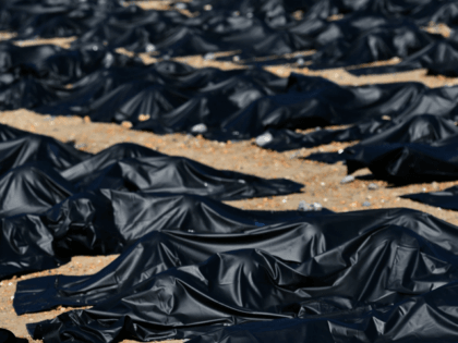 An Amnesty International supporter is pictured in a 'body bag' on Brighton beach in southern England, on April 22, 2015, during a photocall by Amnesty International to highlight what they claim is Britain's shameful response to the refugee and migrant crisis in the Mediterranean. Around 50 supporters of the London-based …