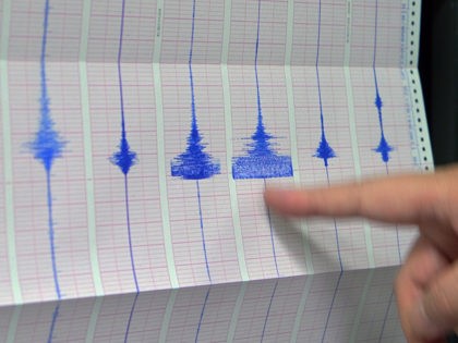 A staff member of the Seismology Center, points on a chart of the earthquake activity detected by the central Weather Bureau in Taipei on February 22, 2014. A 5.4-magnitude earthquake jolted northeastern Taiwan early on February 22, the Seismology Centre said, but there were no immediate reports of casualties or …