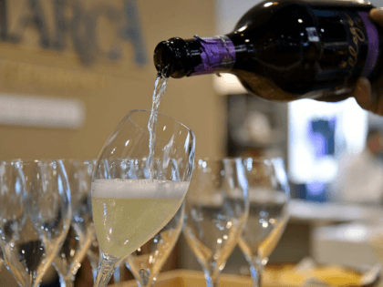 A person poors a glass of Prosecco on April 10, 2016 during the 50th edition of the Vinitaly wine exhibition in Verona. Vinitaly is the worlds largest wine event, hosting more than 4164 exhibitors, looking to promote a vast range of rich and exotic varieties of wines, spirits and other …