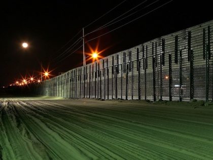 YUMA, AZ Graded earth, lights, and a steel border extend east from the border crossing at