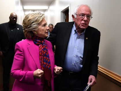 US Democratic presidential nominee Hillary Clinton talks with Bernie Sanders backstage before a campaign rally in Raleigh, North Carolina, on November 3, 2016. / AFP / JEWEL SAMAD (Photo credit should read JEWEL SAMAD/AFP/Getty Images)