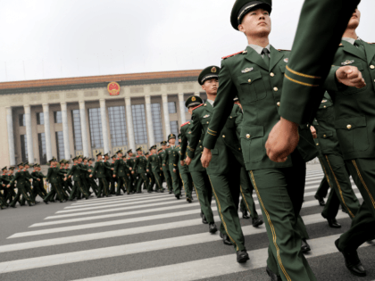Chinese paramilitary policemen march outside the Great Hall of the People after attending a ceremony to commemorate the 90th anniversary of the founding of the People's Liberation Army, in Beijing on August 1, 2017. China will fiercely protect its sovereignty against "any people, organisation or political party", President Xi Jinping …