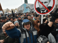 Activists hold placards depicting Russian President Vladimir Putin during a rally calling for the ousting of the Ukrainian President organized by Movement of The New Forces which is led by former Georgian President Mikheil Saakashvili in Kiev on March 18, 2018. / AFP PHOTO / Genya SAVILOV (Photo credit should …