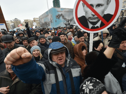 Activists hold placards depicting Russian President Vladimir Putin during a rally calling for the ousting of the Ukrainian President organized by Movement of The New Forces which is led by former Georgian President Mikheil Saakashvili in Kiev on March 18, 2018. / AFP PHOTO / Genya SAVILOV (Photo credit should …