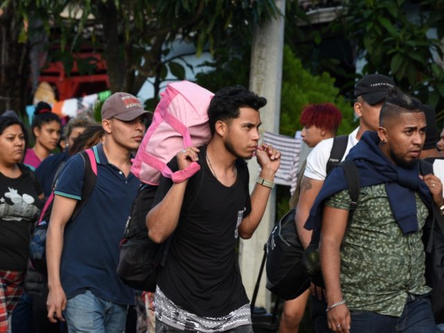 Honduran migrants heading to the United States with a second caravan walk upon arrival at the customs in Agua Caliente, in the Honduras-Guatemala border on January 15, 2019. - Hundreds of Hondurans have set out on a trek to the United States, forming another caravan that US President Donald Trump …