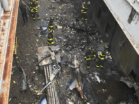 In this handout photo provided by the New York City Fire Department, firefighters work on the roof of 787 Seventh Avenue at 51st Street after a helicopter crashed there on June 10, 2019 in New York City. One person, reportedly the pilot and only person on board, was killed. (Photo …