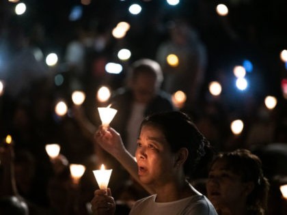 People attend a candlelight vigil at Victoria Park in Hong Kong on June 4, 2019, to mark the 30th anniversary of the 1989 Tiananmen crackdown in Beijing. - Large crowds turned out for a mass candlelight vigil in Hong Kong on June 4 evening marking 30 years since China's bloody …