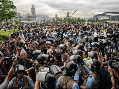 Residents argue with police officers at the Tamar Park outside the Central Government Complex on June 13, 2019 in Hong Kong China. Hong Kong's Legislative Council delayed a second reading of the controversial extradition on Thursday after police and protesters clashed outside government buildings as tensions continue over the bill …