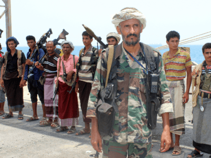 Huthi rebels stand at attention at the Saleef port on May 11, 2019, in the Red Sea port of Hodeidah, ahead of their withdrawal. - A senior pro-government official in Yemen accused Huthi rebels of faking an announced pullout Saturday from three Red Sea ports, as a UN source said …