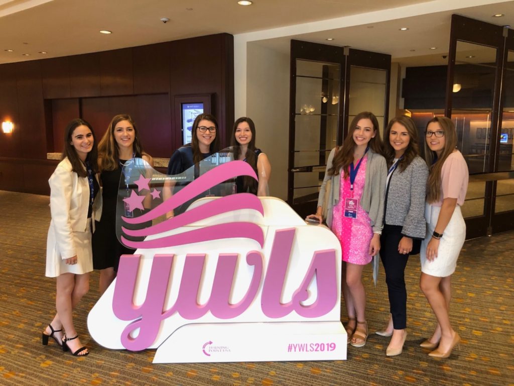 TPUSA attendees pose with event sign