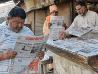 Indian men read newspapers displaying front page news on the Easter Sunday bombings in Sri Lanka, at a roadside stall in Amritsar on April 22, 2019. - The death toll from bomb blasts that ripped through churches and luxury hotels in Sri Lanka rose dramatically April 22 to 290 -- …