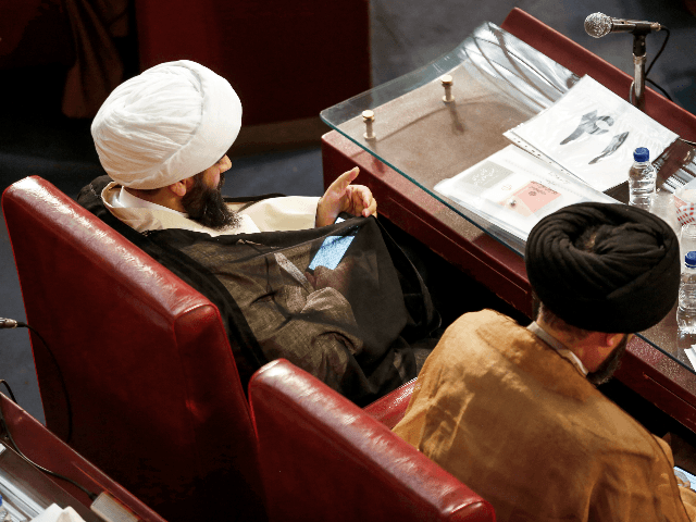 A picture taken on March 13, 2018 shows a member of Iran's Assembly of Experts using his phone while attending a session in the capital Tehran. / AFP PHOTO / ATTA KENARE (Photo credit should read ATTA KENARE/AFP/Getty Images)