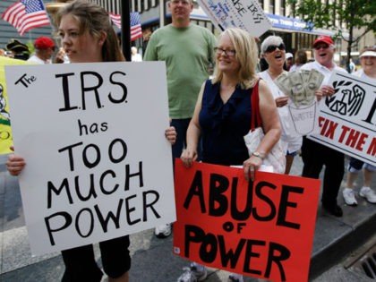 In this May 21, 2013, file photo, tea party activists demonstrate on Fountain Square before marching to the John Weld Peck Federal Building in Cincinnati to protest the Internal Revenue Service's targeting of conservative groups seeking tax-exempt status. On Wednesday, April 4, 2018, a federal judge gave preliminary approval to …
