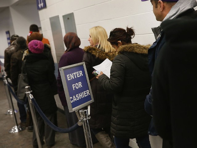 CHICAGO, IL - DECEMBER 10: Illinois residents wait in line at a driver services facility on December 10, 2013 in Chicago, Illinois. Illinois recently began a Temporary Visitors Driver's License (TVDL) program which allows undocumented immigrants to obtain a driver's license. The applicants must have an Illinois address, prove 12 months of residency in the state, and have a valid passport or consular card to be eligible. (Photo by Scott Olson/Getty Images)