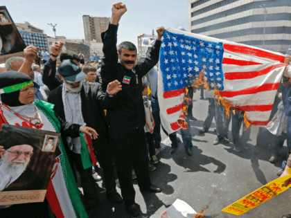 Iranian demonstrators burn a makeshift US flag during a rally …
