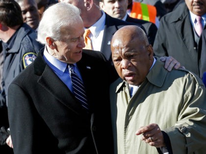 Vice President Joe Biden embraces U.S. Rep. John Lewis, D-Ga., as they prepare to lead a g