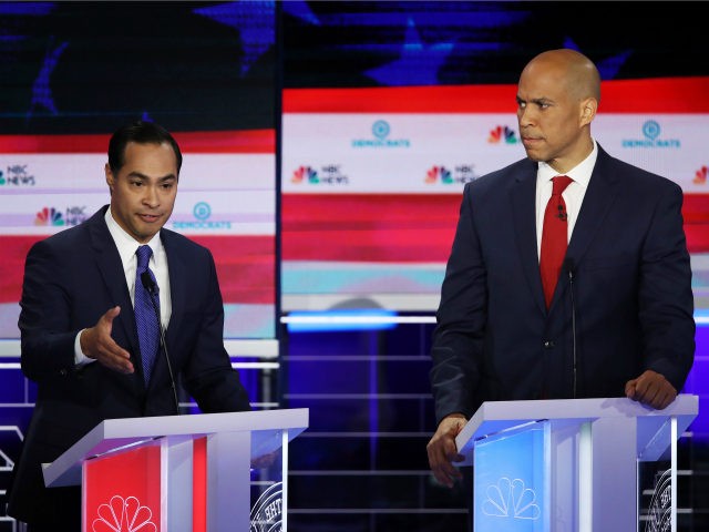 Former housing secretary Julian Castro and Sen. Cory Booker (D-NJ) take part in the first