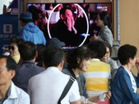 People watch a TV screen showing an image of senior North Korean official Kim Yong Chol in a musical performance by the wives of Korean People's Army officers in North Korea during a news program at the Seoul Railway Station in Seoul, South Korea, Monday, June 3, 2019. A senior …