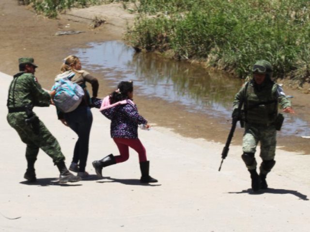 Mexican National Guard troops appear to stop Central American migrants from crossing border into U.S. (Photo: Hector Martinez/AFP)