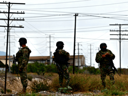 Three members of the Mexican army keep watch in the residential Anahuac neighborhood in Mo