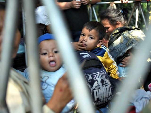 Honduran migrants heading to the United States with a second caravan travel aboard a pick-