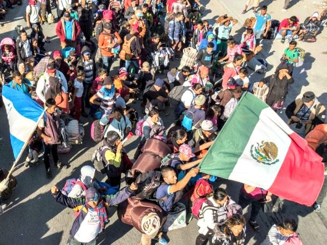 Central American migrants arrive in Tijuana, Mexico, on Thursday. (Guillermo Arias / AFP / Getty Images)