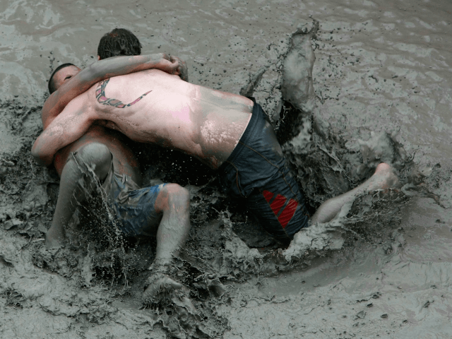 BORYEONG, SOUTH KOREA - JULY 17: Participants wrestle in the mud during the 13th Annual Boryeong Mud Festival at Daecheon Beach on July 17, 2010 in Boryeong, South Korea. Now in its 13th year, the festival features mud wrestling, mud sliding and a mud king contest. (Photo by Chung Sung-Jun/Getty …