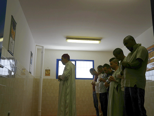 In this photo taken on Friday, June 23, 2017, inmates pray with the Imam Mimoun El Hachmi, left, inside the Terni penitentiary. Stunned that Berlin market attack suspect spent time in Italian jails, Italy turns to “moderate” imams to discourage radicalization among Muslim inmates. (AP Photo/Gregorio Borgia)
