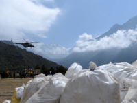 A Nepali Army helicopter flies over waste collected from Mount Everest at Namche Bazar in Solukhumbu district on May 27, 2019, before it is transported to Kathmandu to be recycled. - Some ten tonnes of garbage have been picked from Mount Everest and four bodies retrieved at the end of …