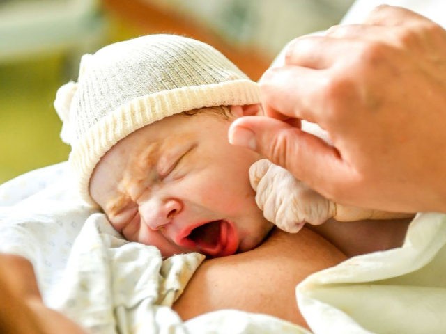 A newborn lies on his mother's stomach after a delivery at the medical clinic St Vincent d