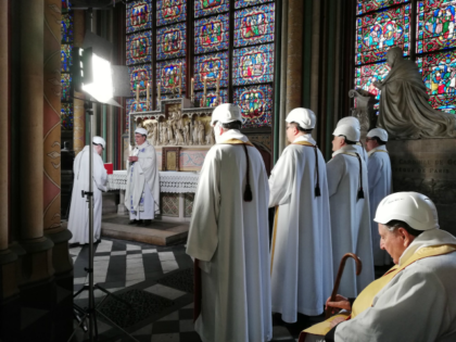 The Archbishop of Paris Michel Aupetit, second left, leads the first mass in a side chapel, two months after a devastating fire engulfed the Notre-Dame de Paris cathedral, Saturday June 15, 2019, in Paris. (Karine Perret, Pool via AP)