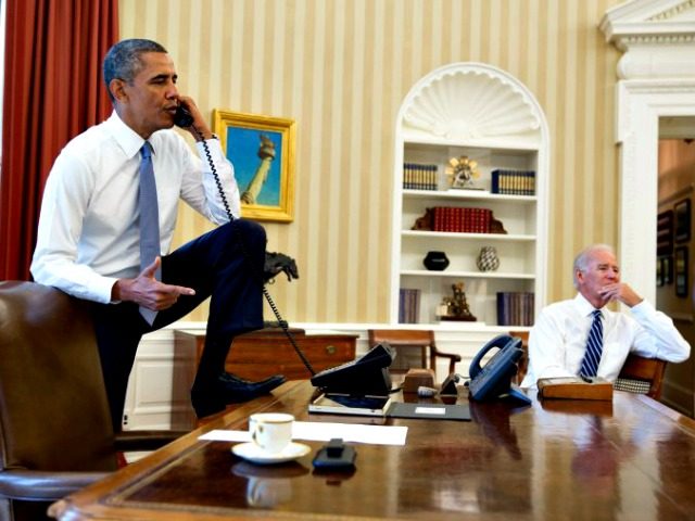 In this official White House photograph, President Barack Obama talks on the phone with Speaker of the House Boehner as Vice President Joe Biden listens in the Oval Office of the White House Aug. 31, 2013 in Washington. (Pete Souza—The White House)