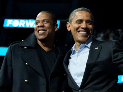 President Barack Obama is flanked on stage by musicians Jay-Z, left, and Bruce Springsteen at a campaign event at Nationwide Arena, Monday, Nov. 5, 2012, in Columbus, Ohio. (AP Photo/Carolyn Kaster)