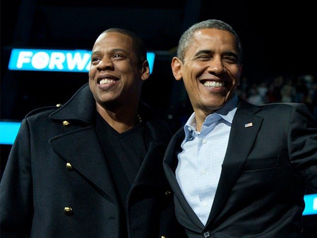 President Barack Obama is flanked on stage by musicians Jay-Z, left, and Bruce Springsteen