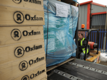 BICESTER, ENGLAND - JANUARY 15: A fork lift truck driver loads water sanitation equipment at Oxfam's logistics warehouse for shipping to Haiti on January 15, 2010 in Bicester, England. A cargo flight, which is being donated free by British Airways, will leave London's Heathrow airport for neighbouring Dominican Republic on …