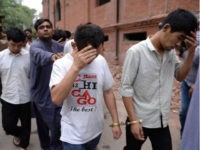 A Pakistani Federal Investigation Agency (FIA) official (3rd L) and a policeman escort to a court handcuffed Chinese nationals accused of allegedly luring young Pakistani girls into fake marriages then forcing them into prostitution in China, on May 11, 2019, in Lahore. - Human Rights Watch raised the alarm over …