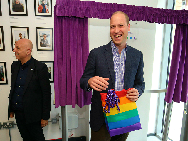 Britain's Prince William, Duke of Cambridge, reacts to receiving a gift bag from trust chi