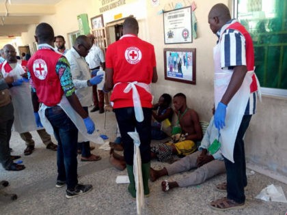 EDITORS NOTE: Graphic content / Red Cross officials attend to victims of a triple suicide bombing, in Konduga, 38 kilometres (24 miles) from the Borno state capital Maiduguri, northeast Nigeria, on June 17, 2019. - Thirty people were killed late on June 16 in a triple suicide bombing in northeast …
