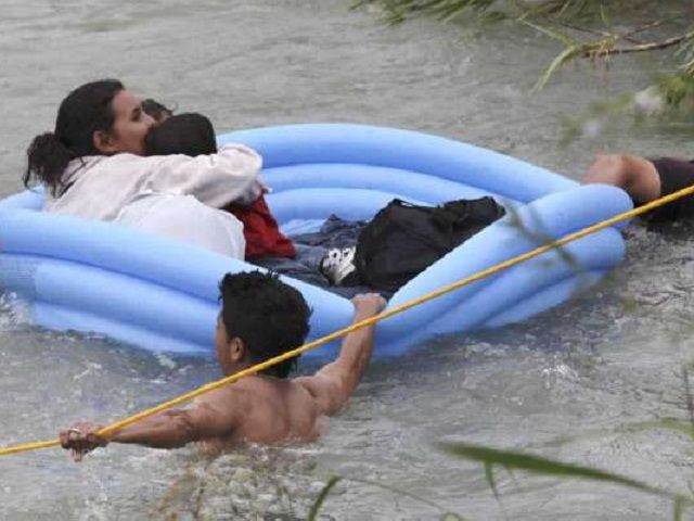 Three migrant rafts approach the U.S. bank of the Rio Grande after illegally crossing from