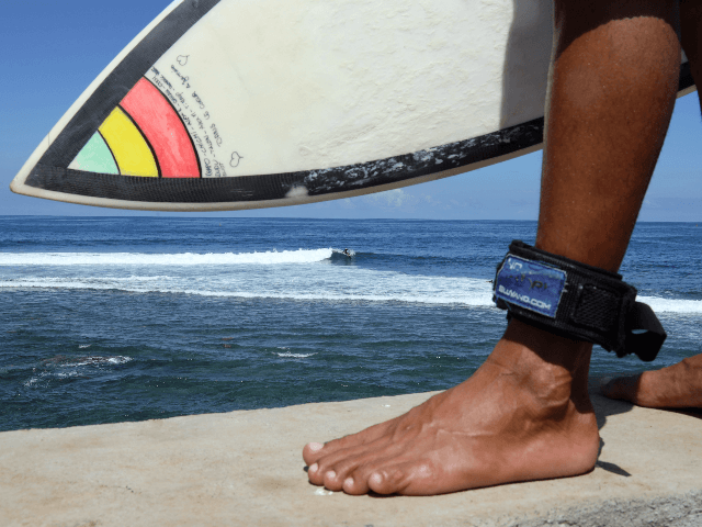 This picture taken on February 25, 2019 shows a surfer wearing a shark repellent leash at