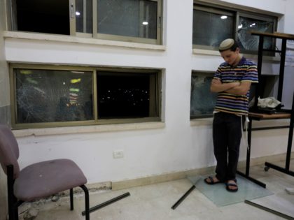 A student stands inside a Jewish religious school in Sderot, Israel, after it was hit by a rocket fired from the Gaza Strip, Thursday, June 13, 2019. (AP Photo/Tsafrir Abayov)