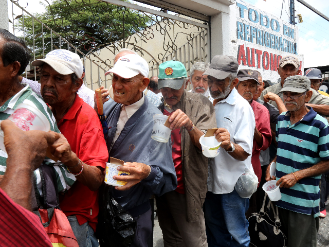 Men stand in line outside Doris Ortegano's house waiting for what may be their only meal f