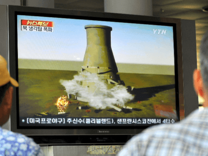 South Koreans watch a TV news programme at a railway station in Seoul, on June 27, 2008 that shows a mock video of the planned blow-up of a cooling tower at North Korea's Yongbyon nuclear complex. Secretive North Korea was preparing a global TV spectacular to dramatise its commitment to …