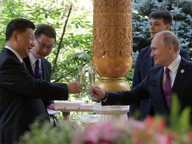 Russian President Vladimir Putin (L) and Chinese President Xi Jinping (R) toast before the fifth regular foreign ministers' meeting of the Conference on Interaction and Confidence Building Measures in Asia (CICA) at the Diaoyutai State Guesthouse in Dushanbe on June 15, 2019. (Photo by Alexei Druzhinin / Sputnik / AFP) (Photo credit should read ALEXEI DRUZHININ/AFP/Getty Images)