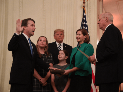 Brett Kavanaugh (L) is sworn-in as Associate Justice of the US Supreme Court by Associate