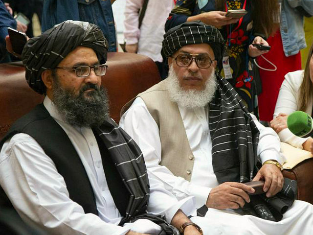 Mullah Abdul Ghani Baradar, the Taliban group's top political leader, left, and Sher Moham