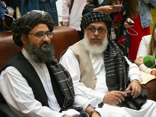 Mullah Abdul Ghani Baradar, the Taliban group's top political leader, left, and Sher Mohammad Abbas Stanikzai, the Taliban's chief negotiator speak to the media Russia, Tuesday, May 28, 2019. Baradar, the Taliban group's top political leader, and a delegation of Taliban are in Moscow where they are meeting other Afghans including former President Hamid Karzai and some of the candidates in the presidential elections. (AP Photo/Alexander Zemlianichenko)