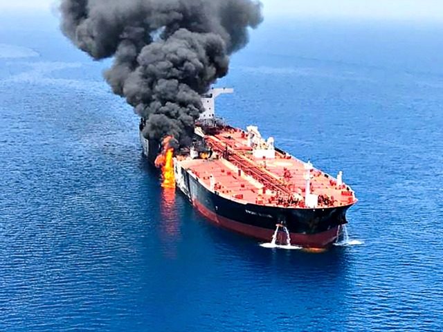 A picture obtained by AFP from Iranian News Agency ISNA on June 13, 2019 reportedly shows fire and smoke billowing from Norwegian owned Front Altair tanker said to have been attacked in the waters of the Gulf of Oman. - Suspected attacks left two tankers in flames in the waters …